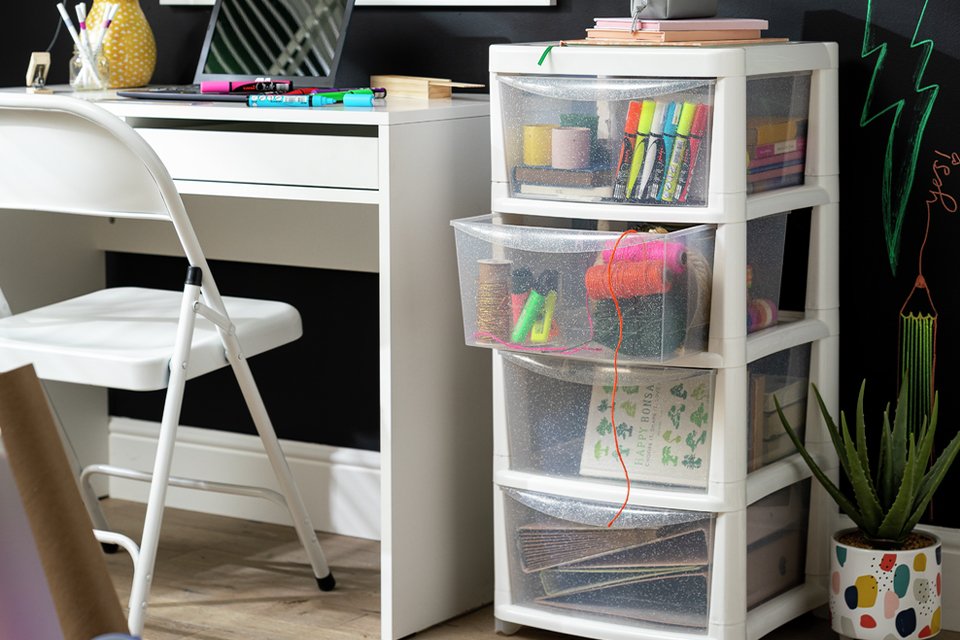 A storage unit near an office table and chair.