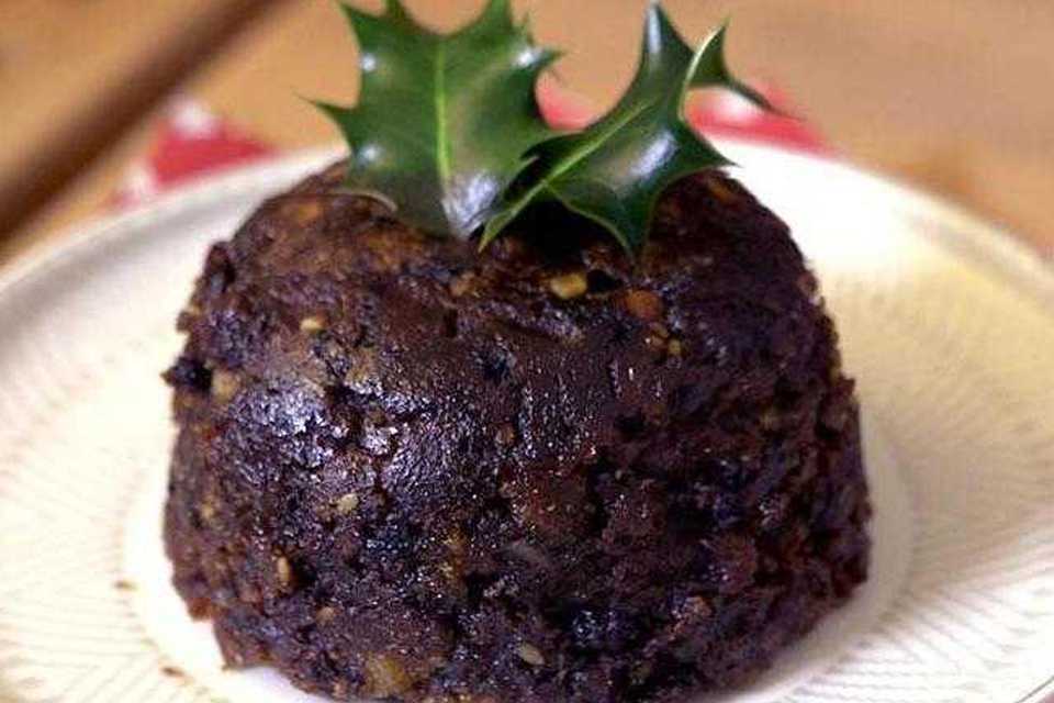 A delicious-looking Christmas pudding on a plate.