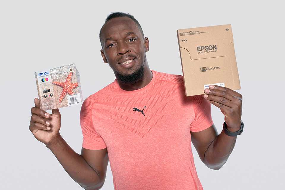 Usain Bolt holding the ReadyPrint ink packaging.