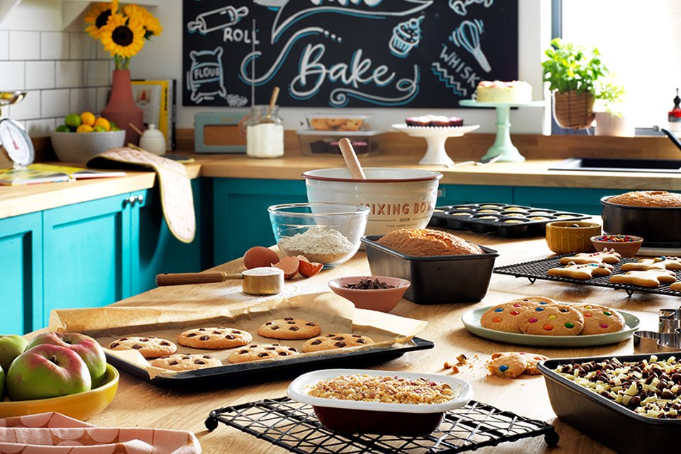 Fruits, cookies and other baked goods on a kitchen table.