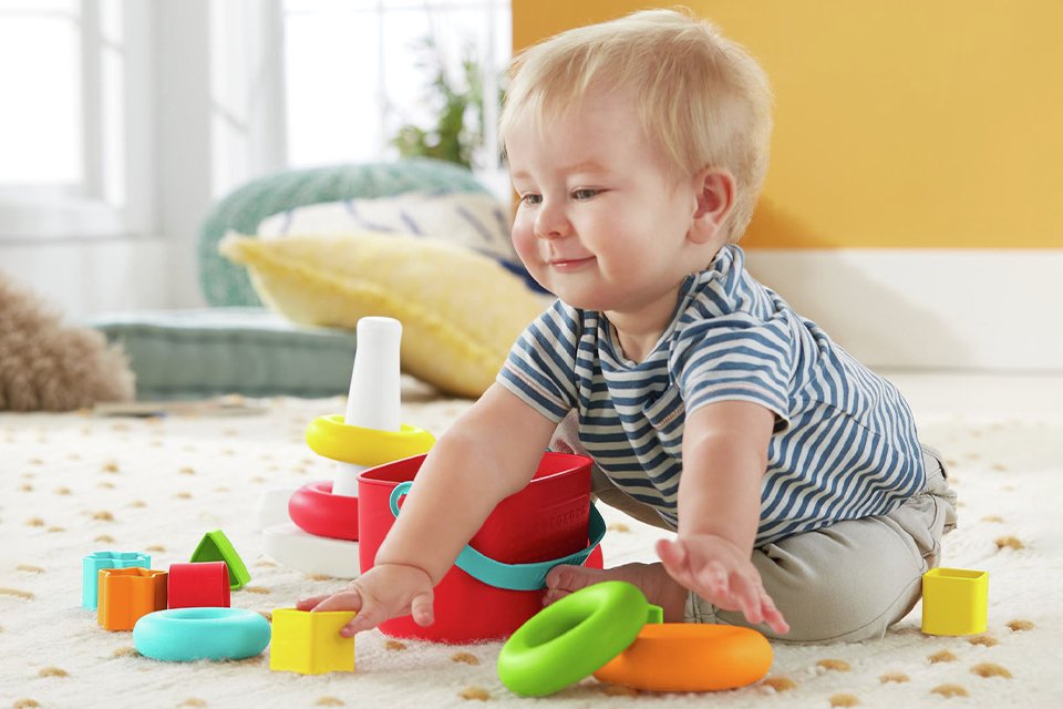 An infant playing with toys.