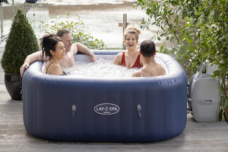A group of friends sitting in a Lay-Z-Spa hot tub.