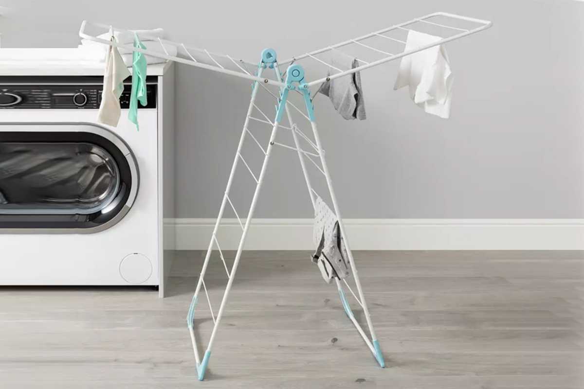 Clothes drying on a clothes airer inside a room.