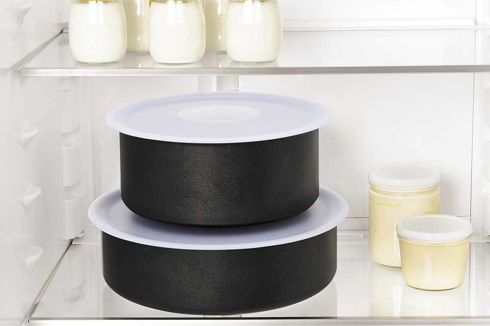 Two Tefal Ingenio pans with lids on, stacked and stored in the fridge.