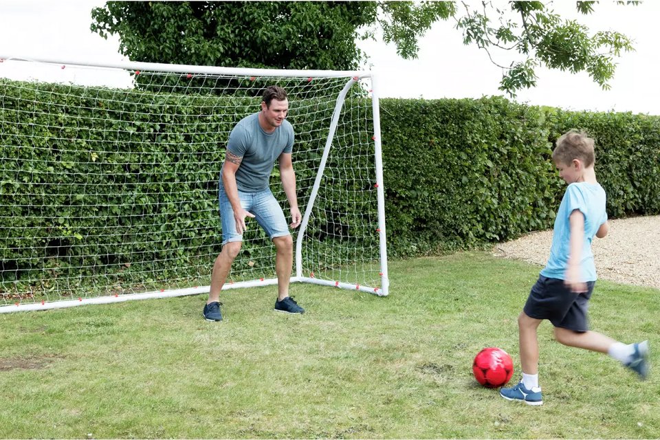 A father and son playing footbal with Opti 10 x 6ft PVC Football Goal.