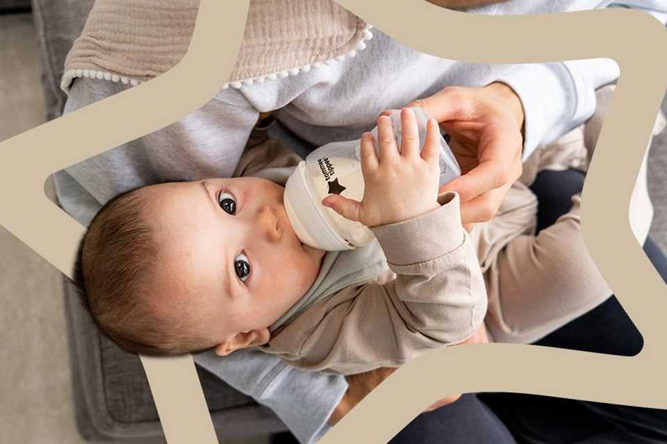  A baby feeding on Tommee Tippee Closer to Nature baby bottle.
