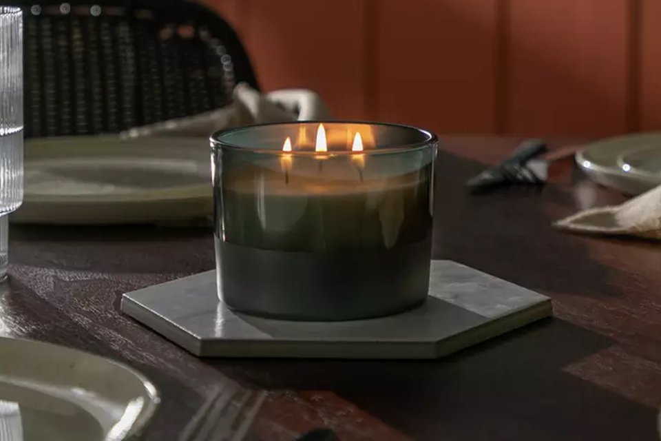 A Habitat scented multi-wick candle with honey and sandalwood fragrance.