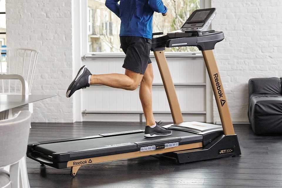 A man using Reebok Jet 300+ treadmill.