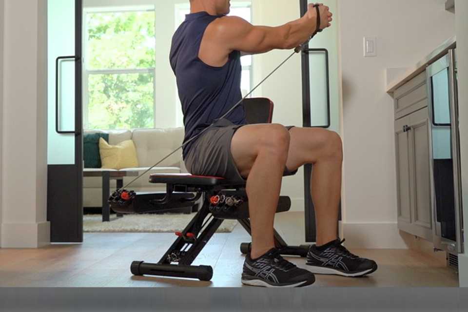 A man using an Inspire Fitness M2 multi-gym.