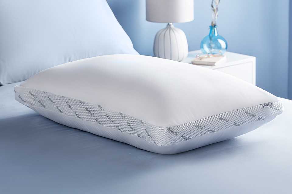 A white Silentnight pillow on a bed.