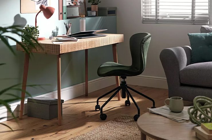 Rattan inspired office desk with black office chair.