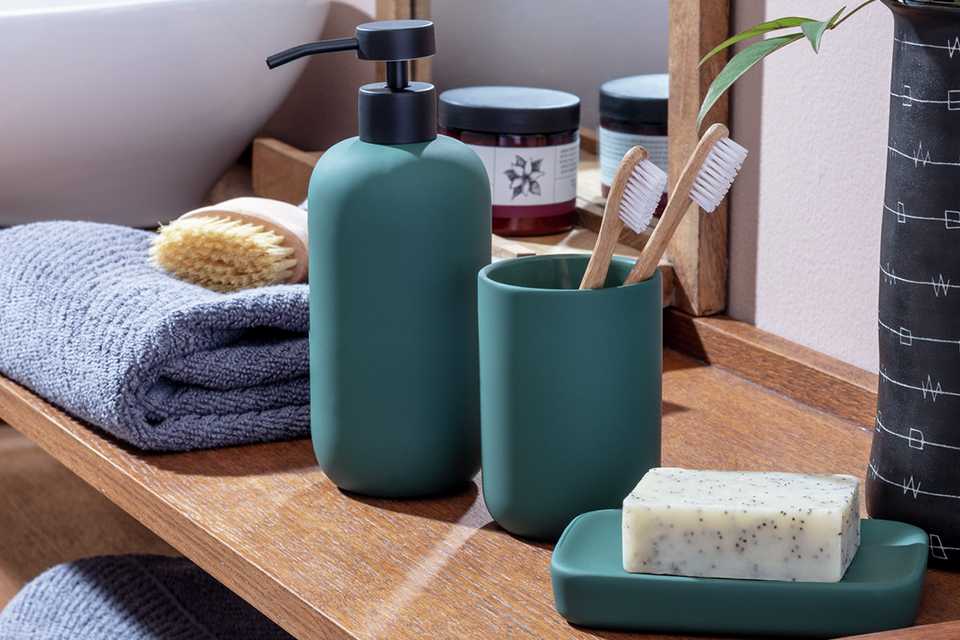 A Habitat soft touch dark green bathroom accessory set.