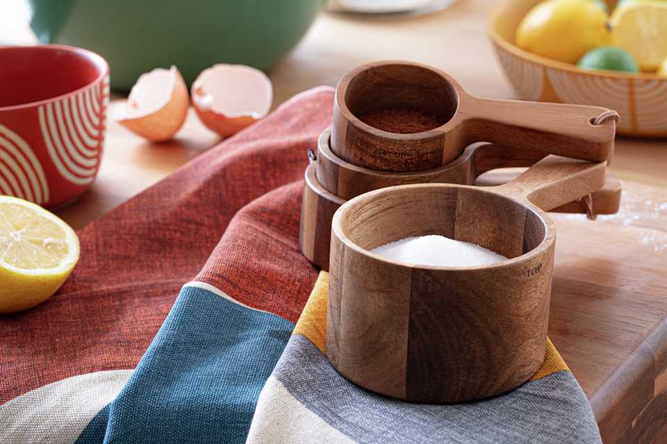 Wooden measuring cups on a dining table.