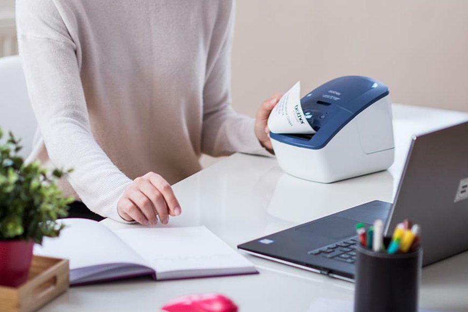 A woman using Brother QL-600B labelling machine.