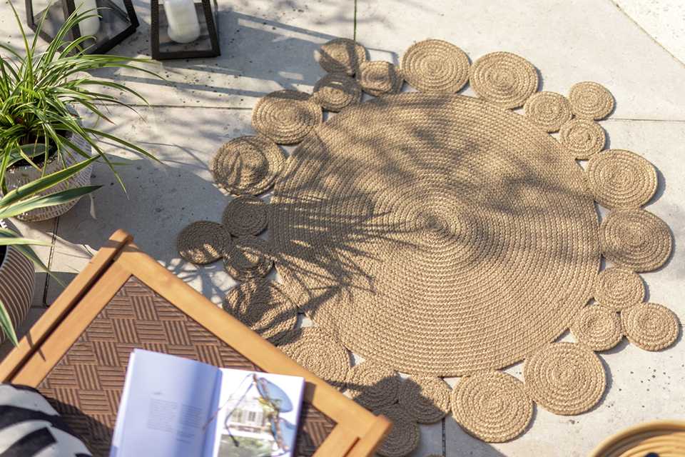 Light brown coloured outdoor rug.