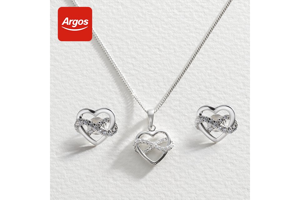 Silver necklace and earrings with a sparkly infinity symbol intwined.