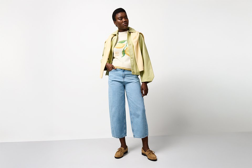 Layered spring outfit with a light jacket over a casual top and trousers, designed for changing spring temperatures and everyday wear. 