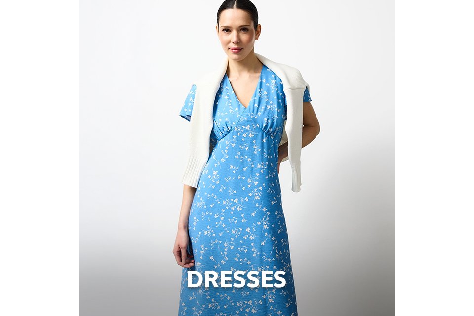 Blue floral midi dress with V-neck detail styled with a white knit sweater for spring and summer weddings.