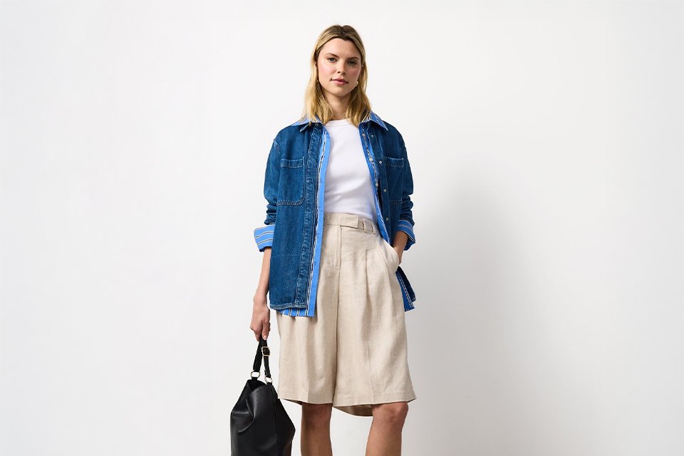 Everyday summer outfit featuring a denim shirt layered over a light dress, ideal for versatile warm‑weather styling. 