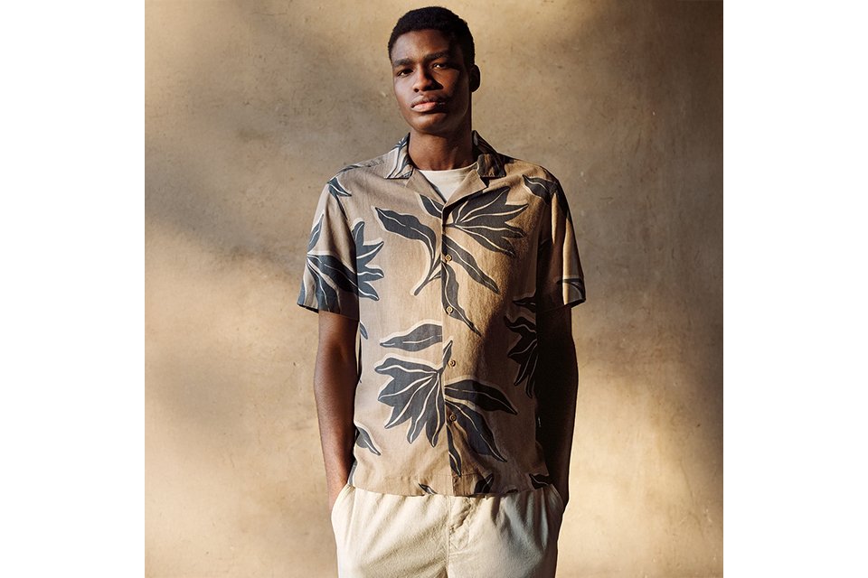 Short sleeve printed shirt paired with casual trousers, styled for men’s new‑in spring and summer clothing.