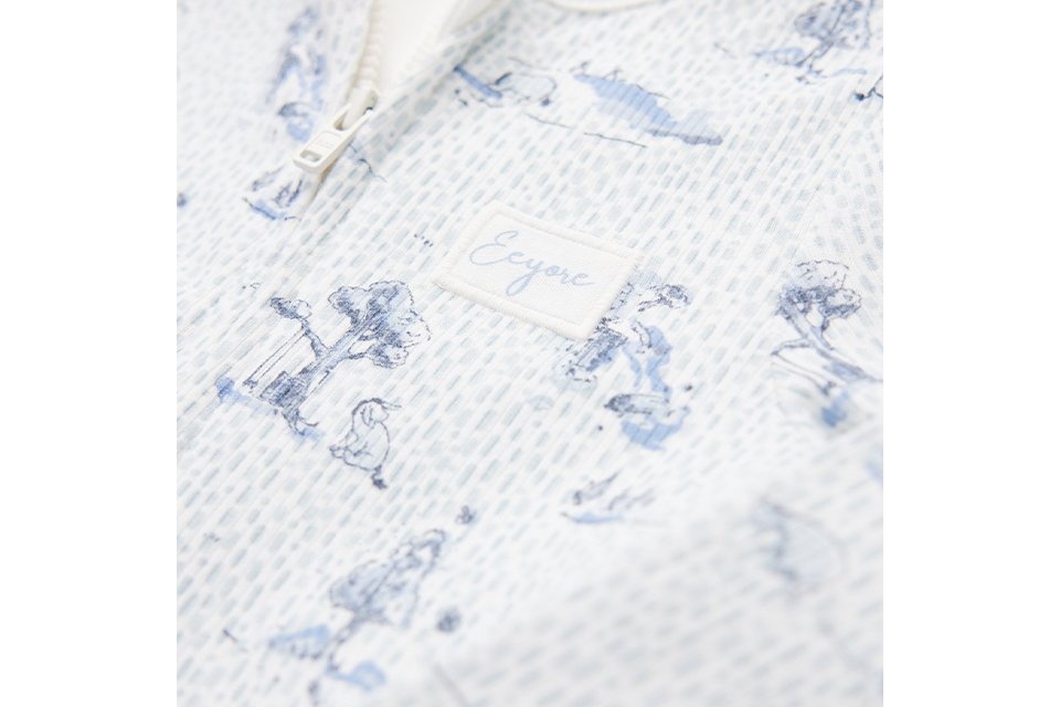 Baby sleepsuit with two‑way zip fastening.