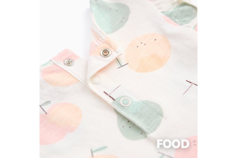 Baby sleepsuit with playful food print.
