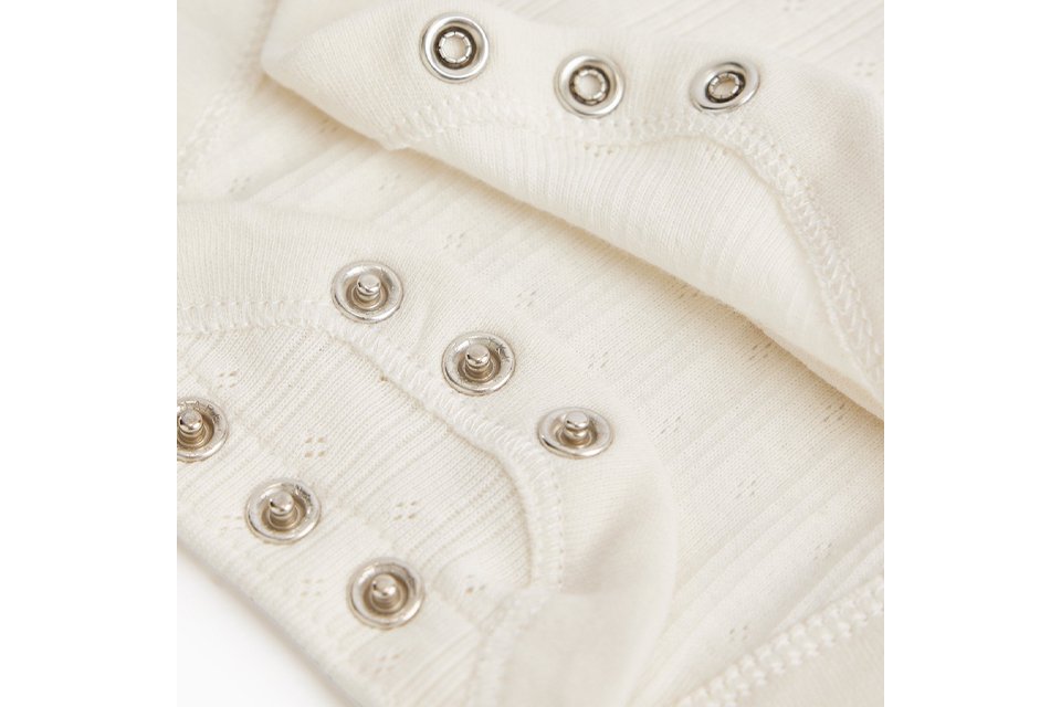 Baby sleepsuit with easy popper fastenings.