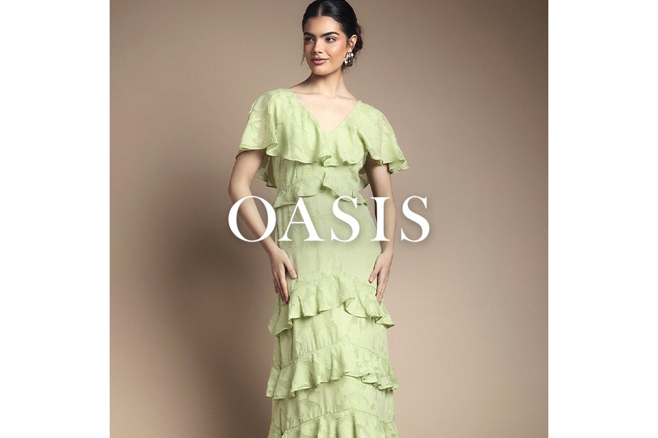 Person wearing a light green maxi dress with multiple cascading ruffle tiers.