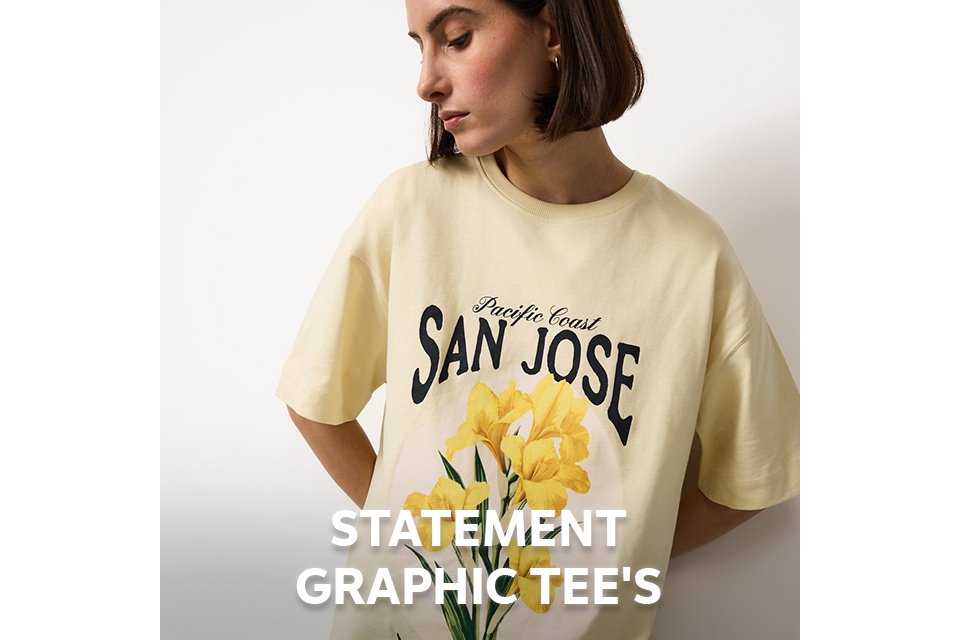 Woman wearing a butter yellow t-shirt with yellow flowers on the front.