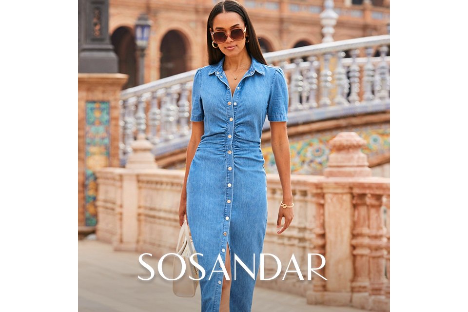 Black and white floral long‑sleeve top paired with high‑waisted black trousers.