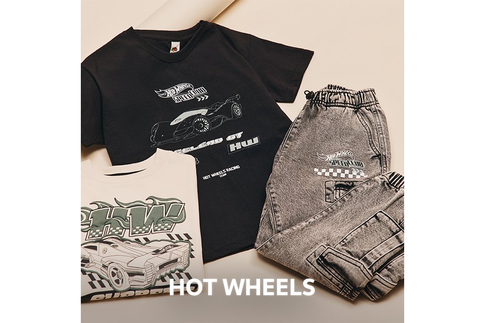 Flat lay of a black Hot Wheels T-shirt with car graphics, paired with grey joggers and additional printed tops.