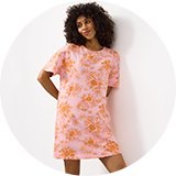 Woman wearing star‑print long pyjama set.