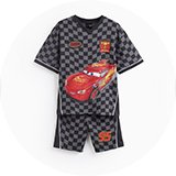 Boy modelling bright graphic pyjamas from the boys’ nightwear range.