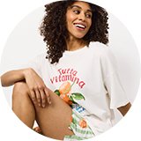 Woman wearing a light grey button‑through nightwear set.