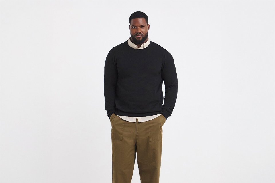 Relaxed smart‑casual workwear outfit with knit and tailored trousers.