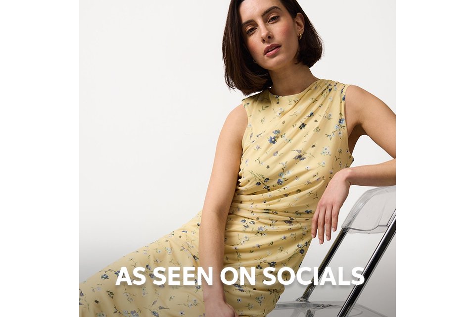 Model wearing a neutral long coat styled for social media fashion trends. 