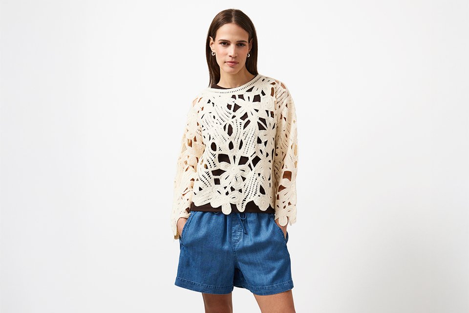Graphic festival T-shirt paired with denim mini skirt, styled for an effortless everyday festival look.