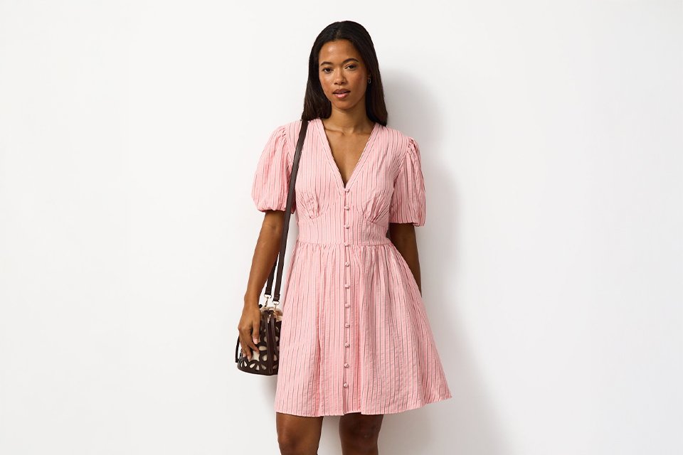 Light summer dress styled with minimal accessories, ideal for relaxed holiday outfits in warm climates.