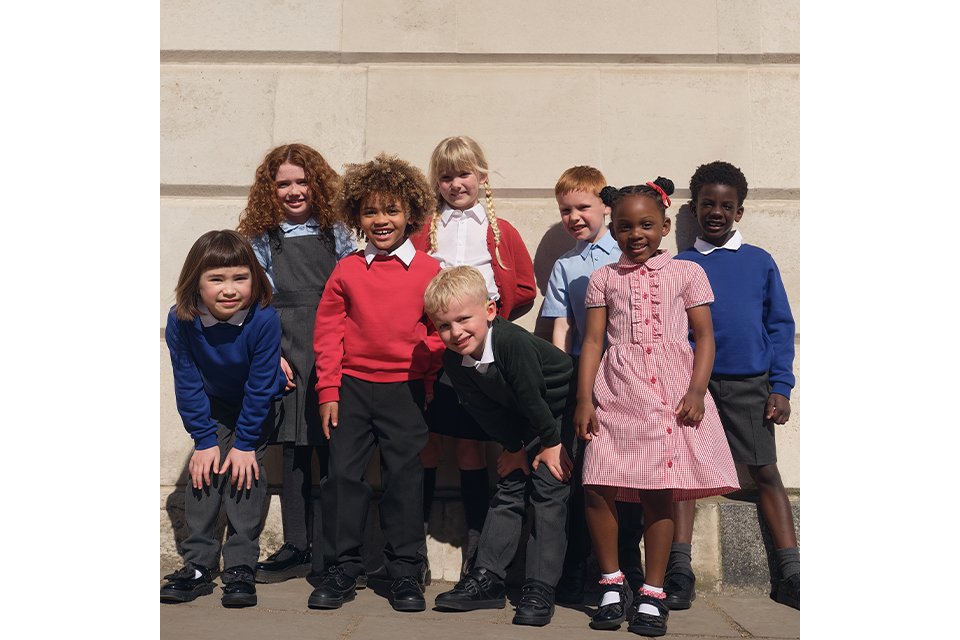 Children’s school uniform styles including sweaters, dresses and trousers, designed for everyday school wear.