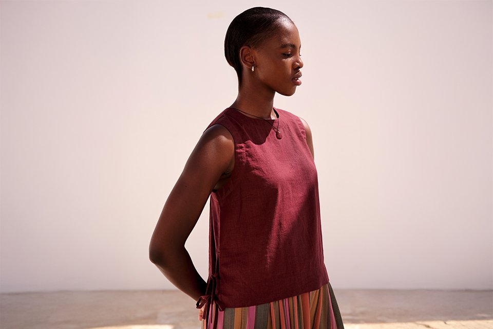 Sleeveless summer top in a bold colour, styled with a printed skirt for a breathable warm‑weather outfit.