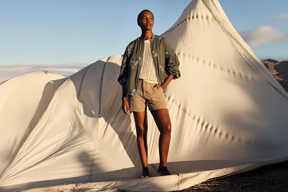 Breathable linen shirt styled with tailored shorts for a relaxed warm‑weather outfit.