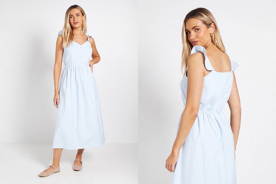 Back view of a pale blue sleeveless midi dress with soft fabric drape for evening wedding wear. 