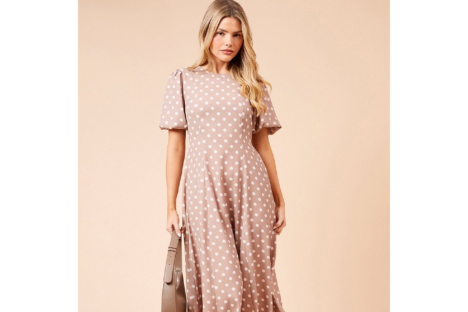 Blue and white floral long sleeve midi dress styled with a light blue cardigan, silver block‑heel sandals and drop earrings on a white background.