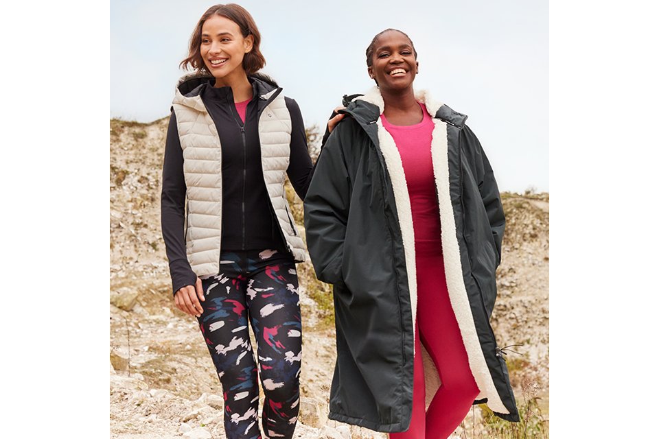 Models wearing sporty layered outfits including padded gilets, jackets and patterned trousers for casual spring looks.