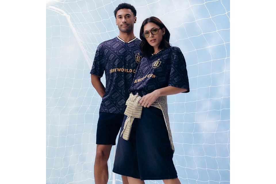 A woman and a man wearing a dark blue football top.