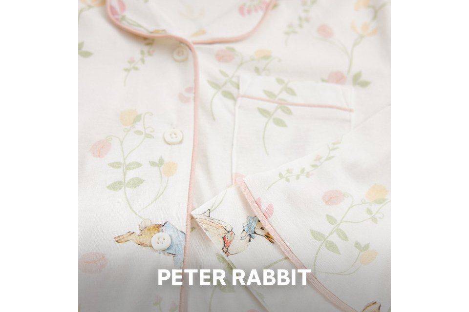 Close up shot of a piece of kids clothing showing a Peter Rabbit pattern.