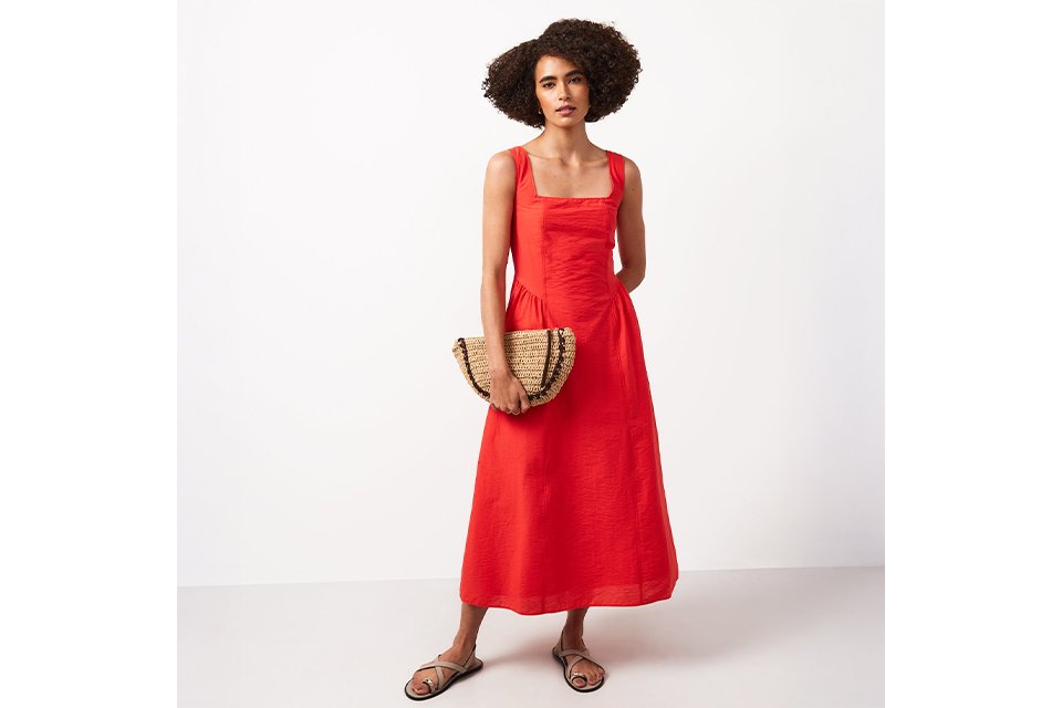 Woman wearing a red midi dress.