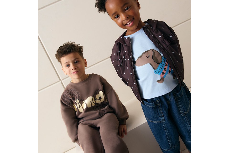 Children's casual clothing collection featuring graphic sweatshirt, printed T-shirt, lightweight polka dot jacket and denim trousers in a stylish everyday outfit.
