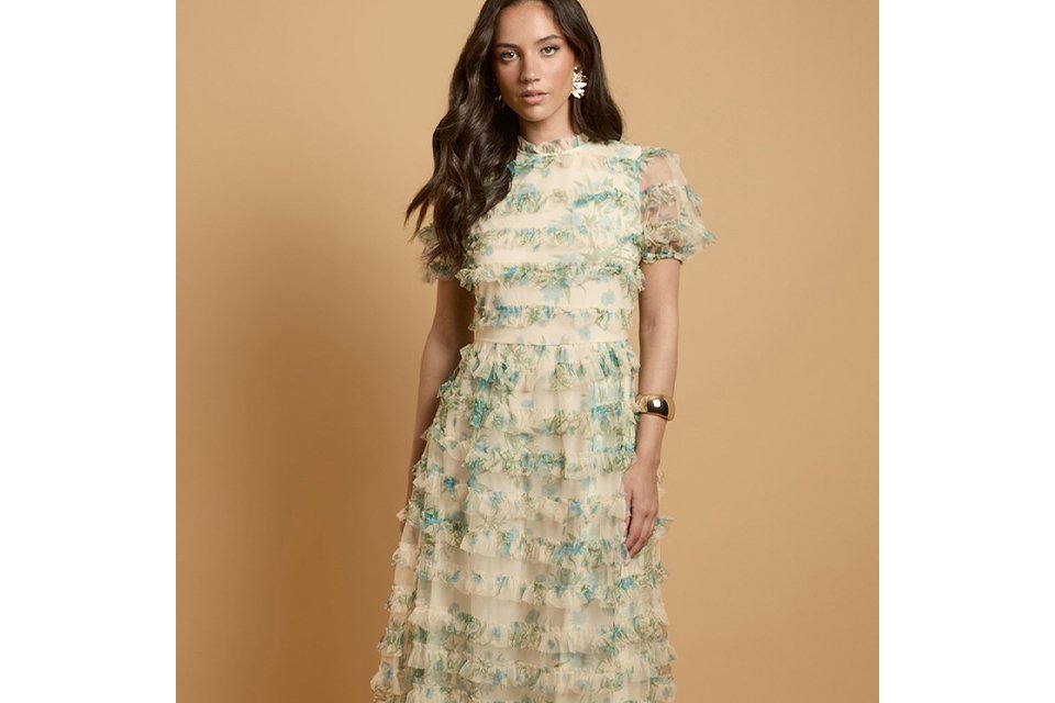 Cream floral ruffle maxi dress with tiered textured layers, short puff sleeves, high neckline and flowing silhouette.