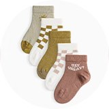 Five-pack baby socks with checkerboard, striped, and slogan designs in soft neutral colours.